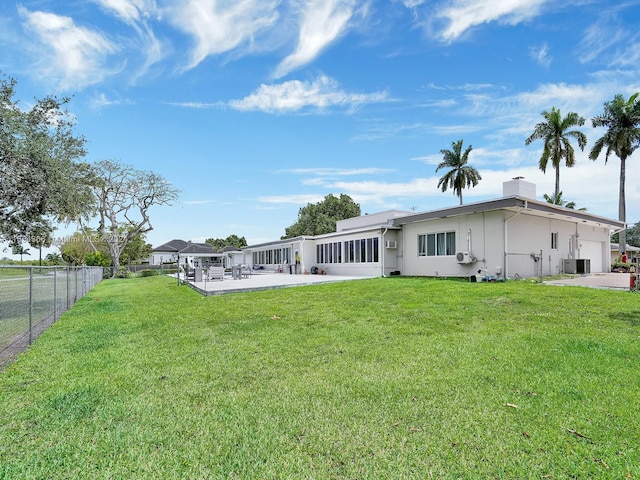 back of property featuring a lawn and a patio