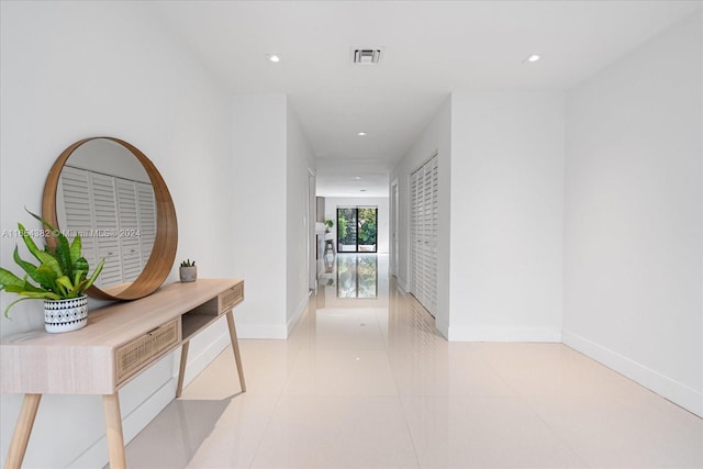 corridor with light tile patterned floors