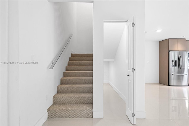 stairs with tile patterned floors