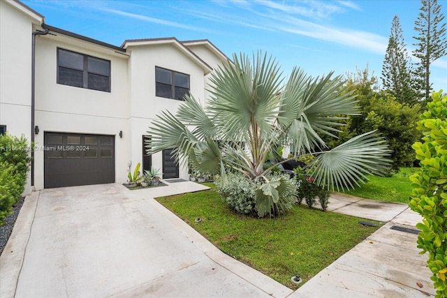 view of front facade with a garage and a front yard