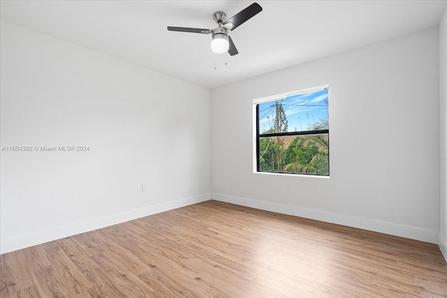 empty room with ceiling fan and light hardwood / wood-style floors