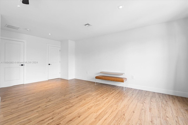 spare room featuring light hardwood / wood-style flooring and ceiling fan