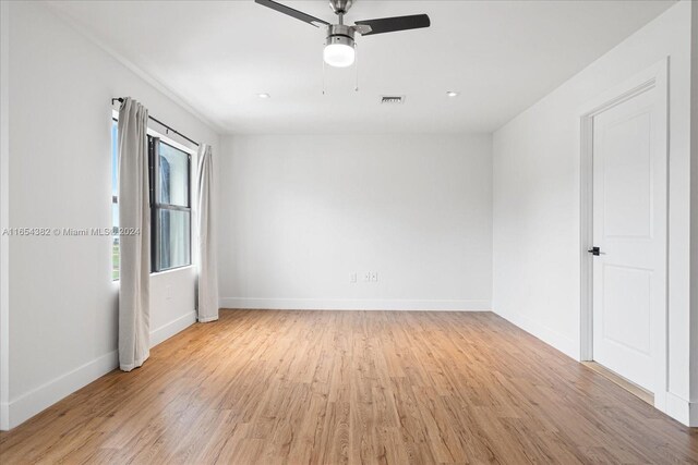 spare room with ceiling fan and light hardwood / wood-style flooring