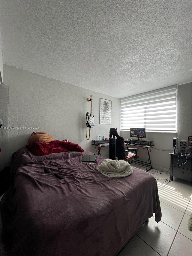 tiled bedroom with a textured ceiling