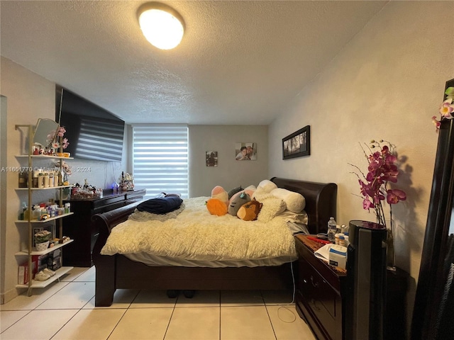 tiled bedroom with a textured ceiling