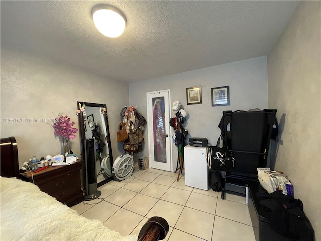 interior space with light tile patterned floors and a textured ceiling