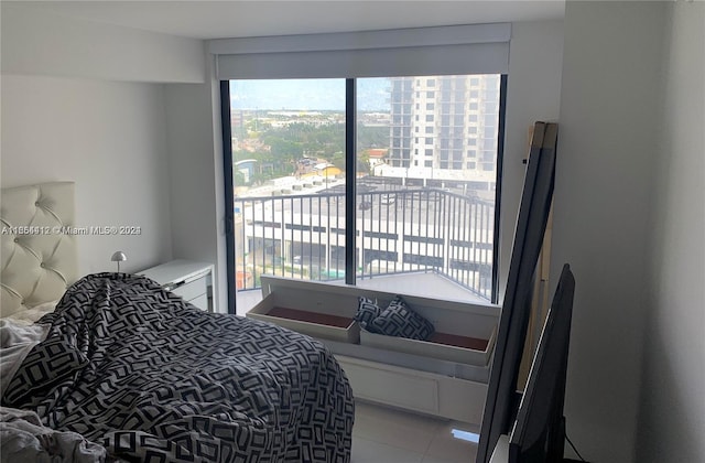 bedroom with tile patterned floors and access to outside