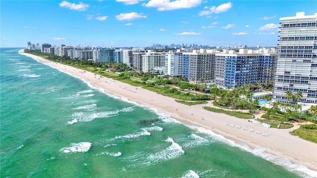 aerial view with a water view and a beach view