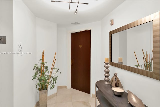 corridor featuring light tile patterned floors