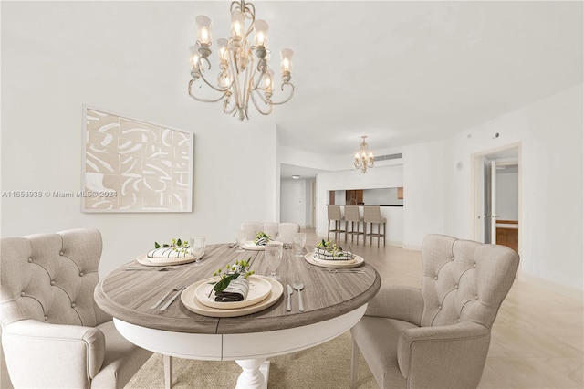 dining room featuring light tile patterned floors and a chandelier