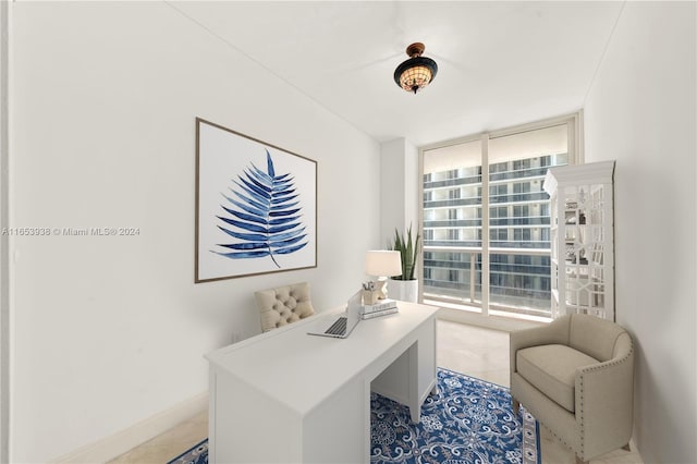 office featuring light tile patterned flooring, a wall of windows, and a wealth of natural light