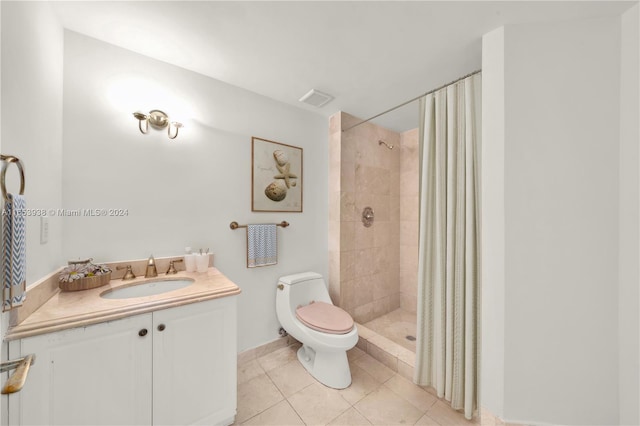 bathroom featuring tile patterned floors, vanity, toilet, and walk in shower