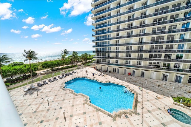 view of swimming pool featuring a water view