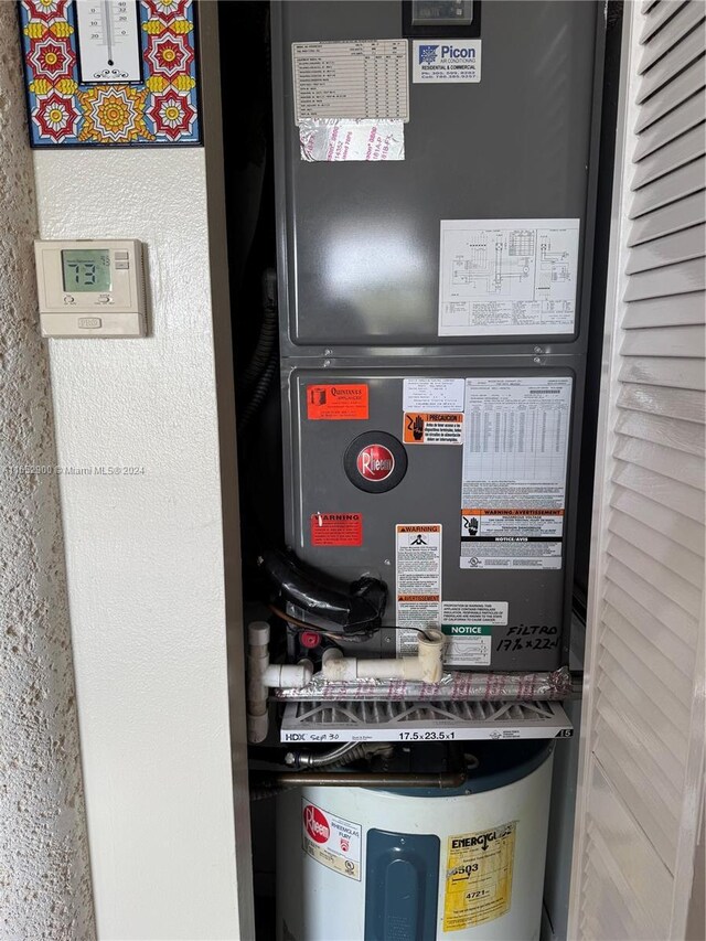 utility room with water heater and heating unit