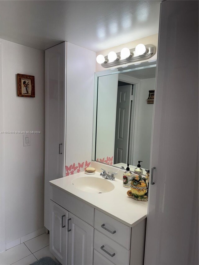 bathroom with tile patterned flooring and vanity