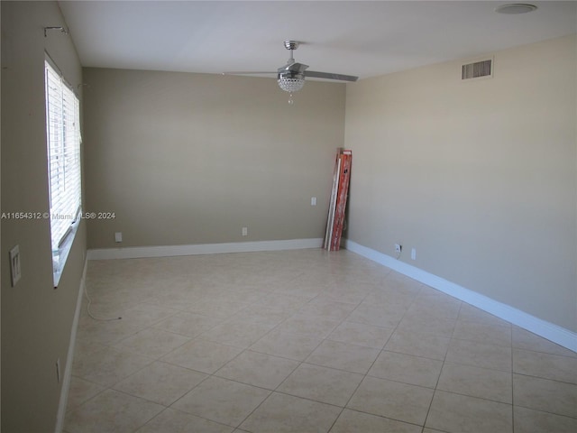 tiled empty room with ceiling fan