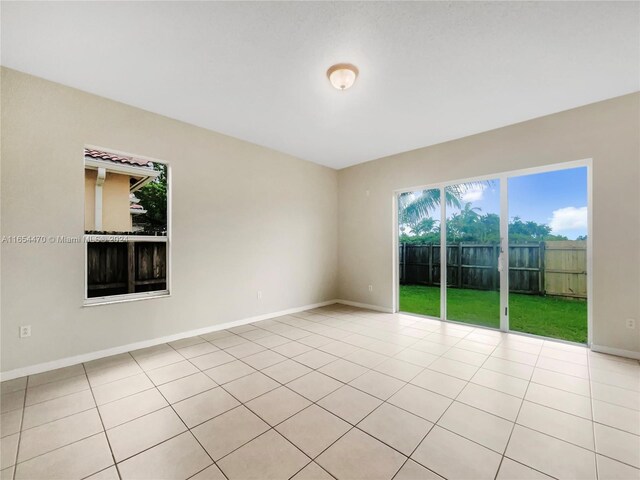 unfurnished room featuring light tile patterned floors