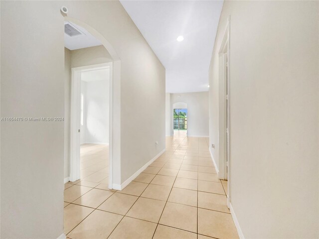 corridor featuring light tile patterned floors