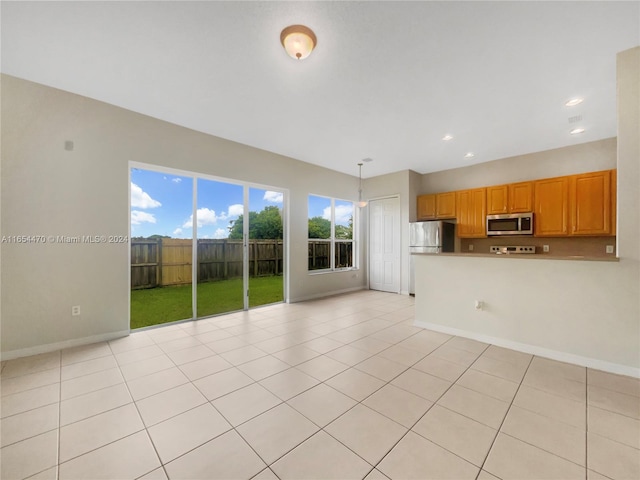 unfurnished living room featuring recessed lighting, baseboards, and light tile patterned flooring