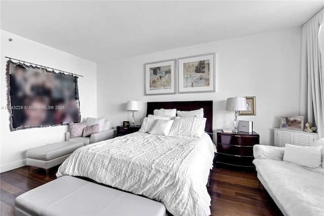 bedroom with dark hardwood / wood-style floors