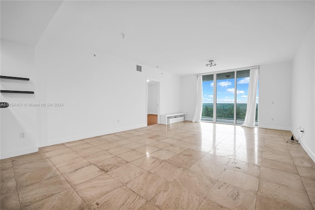 spare room featuring expansive windows