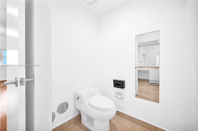 bathroom with toilet and tile patterned floors