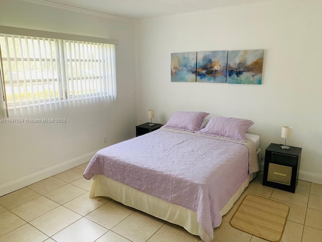 tiled bedroom featuring ornamental molding