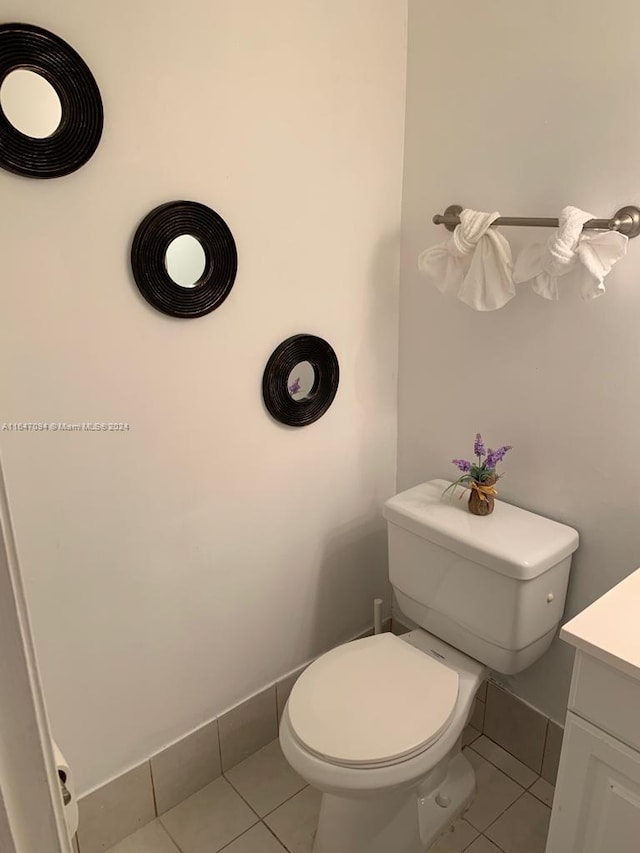 bathroom with vanity, toilet, and tile patterned floors