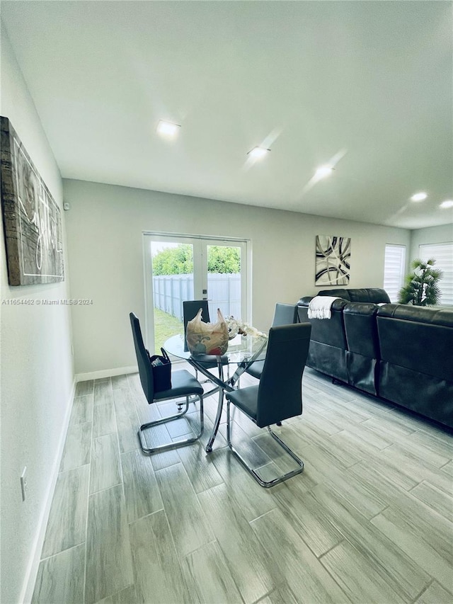 dining area with french doors and light wood-type flooring