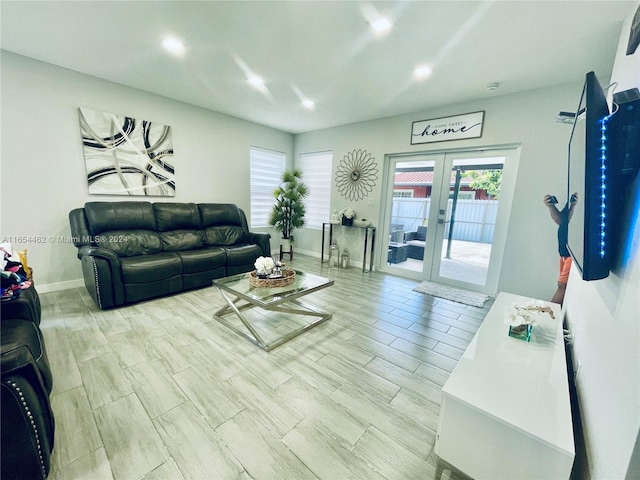 living room featuring french doors and light hardwood / wood-style floors