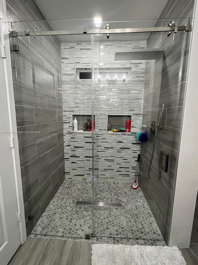 bathroom featuring a shower with shower door