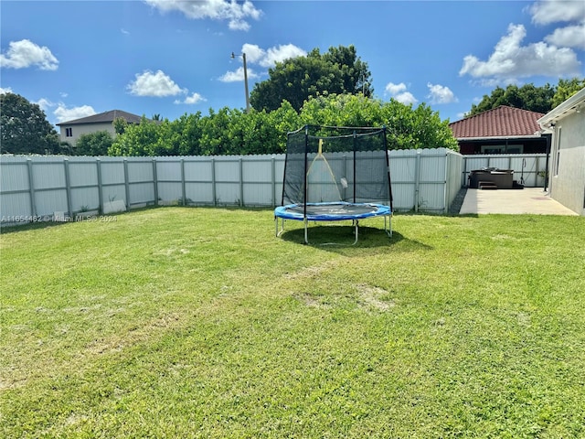 view of yard with a patio and a trampoline