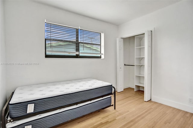 bedroom with a closet and wood-type flooring