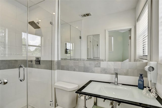 bathroom with toilet and an enclosed shower