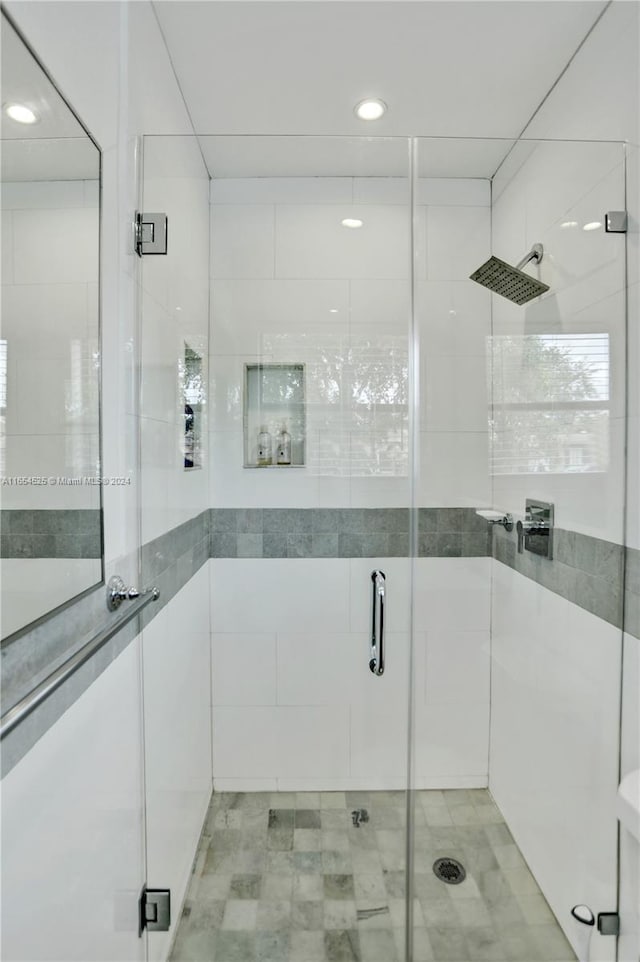 bathroom featuring a shower with door