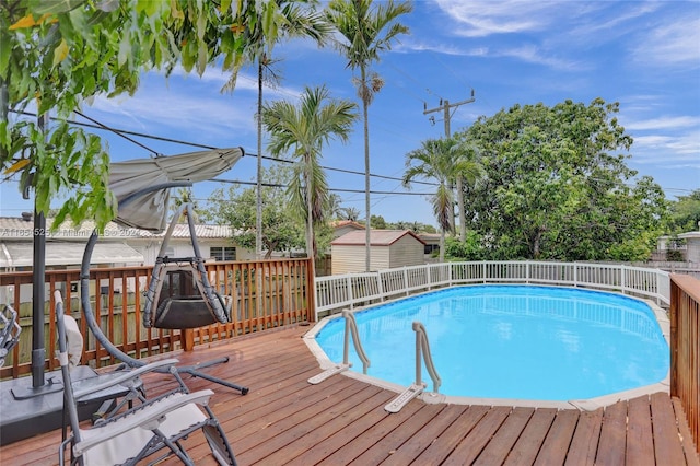 view of swimming pool with a deck