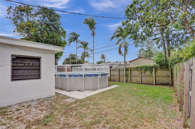 view of yard with a fenced in pool