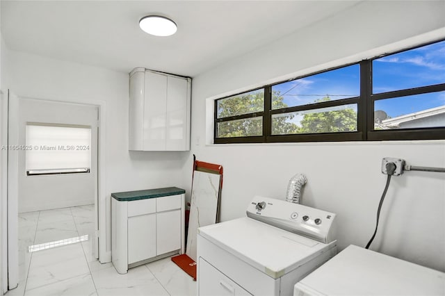 laundry area featuring cabinets and washing machine and dryer