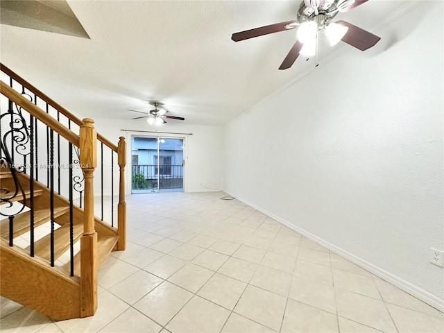 tiled spare room featuring ceiling fan and a textured ceiling