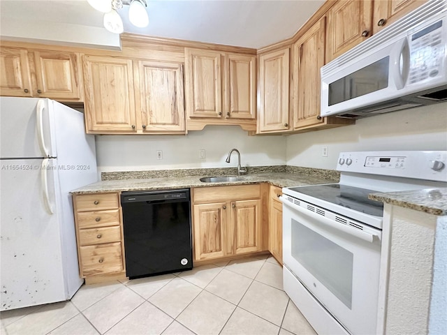 kitchen with white appliances, light brown cabinetry, sink, light stone countertops, and light tile patterned flooring