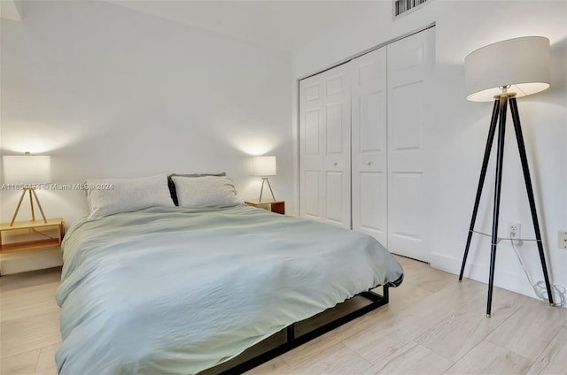 bedroom featuring light wood-type flooring and a closet