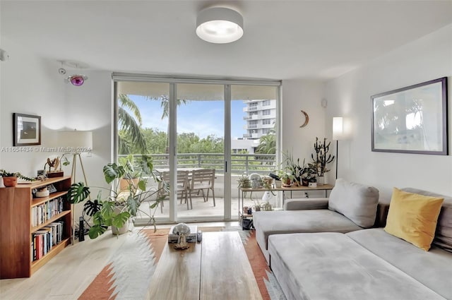 living room featuring floor to ceiling windows and hardwood / wood-style floors