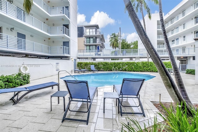 view of swimming pool featuring a patio area