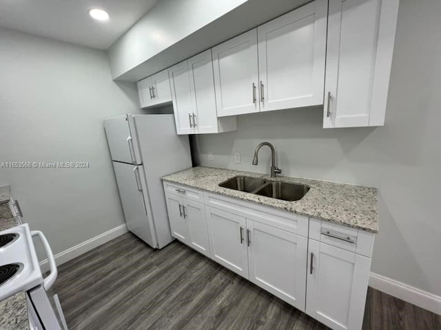 kitchen with white cabinets, white fridge, and sink