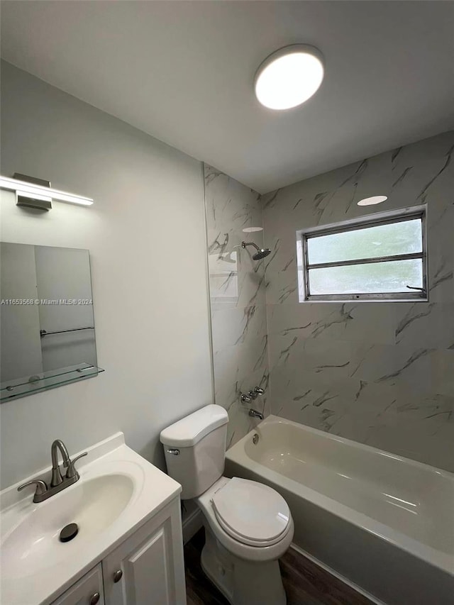 full bathroom featuring vanity, toilet, wood-type flooring, and tiled shower / bath