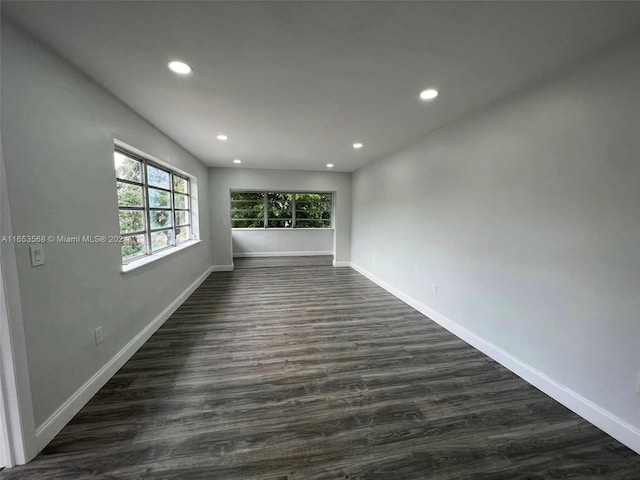 empty room with dark wood-type flooring