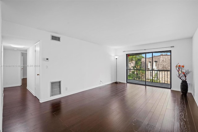 spare room with dark hardwood / wood-style floors