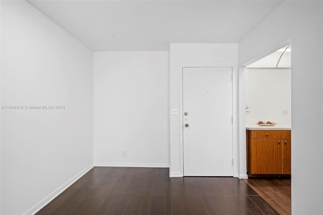 unfurnished room featuring dark hardwood / wood-style flooring