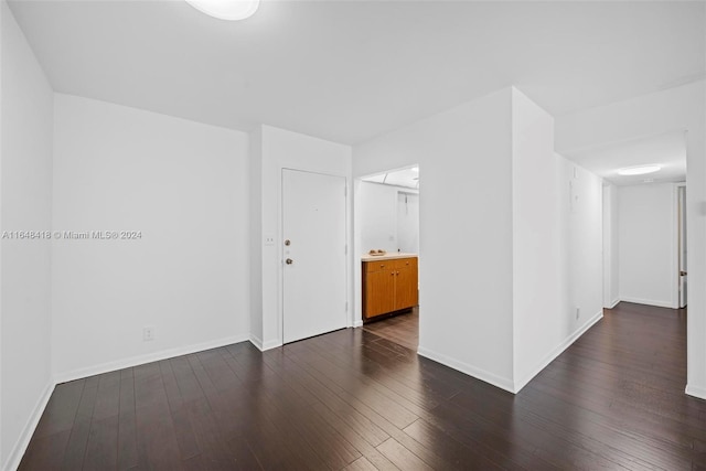 empty room with dark hardwood / wood-style flooring