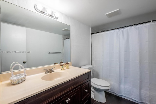 bathroom with vanity, toilet, and a shower with shower curtain